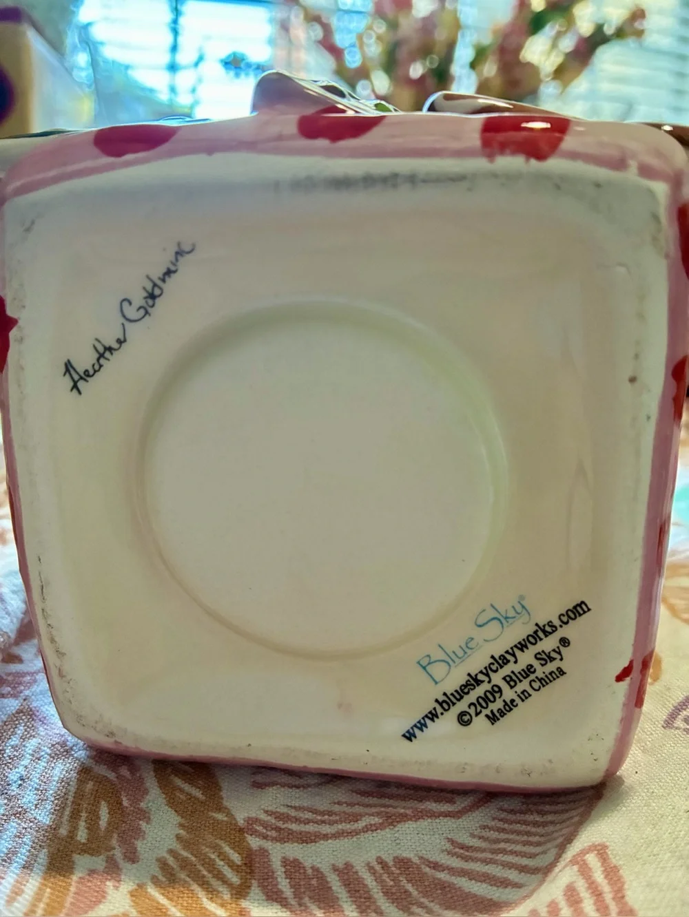 Blue Sky “The Gingerbread Cottage”. In new condition. Pink, brown, red & green.